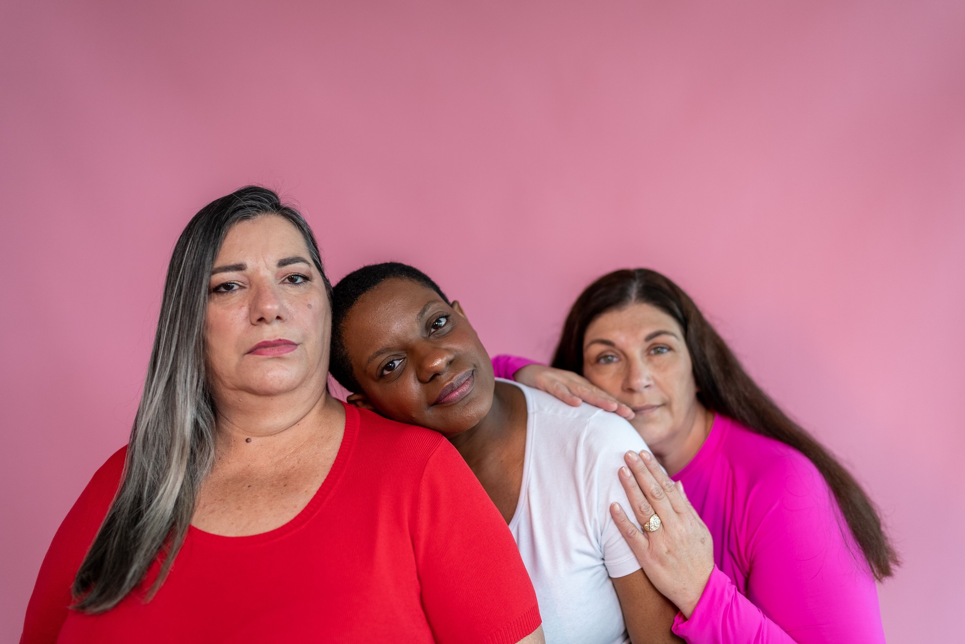 Portrait of friends in a pink background