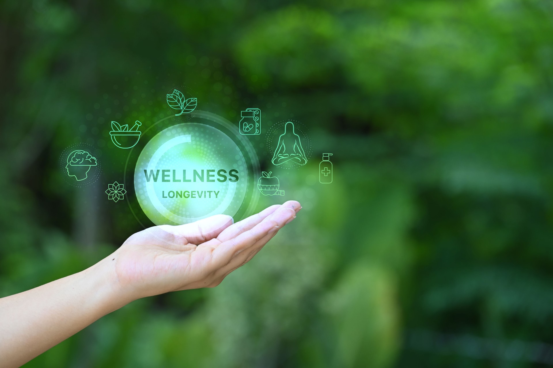 Open hand holding virtual icons representing longevity, health, and holistic wellbeing