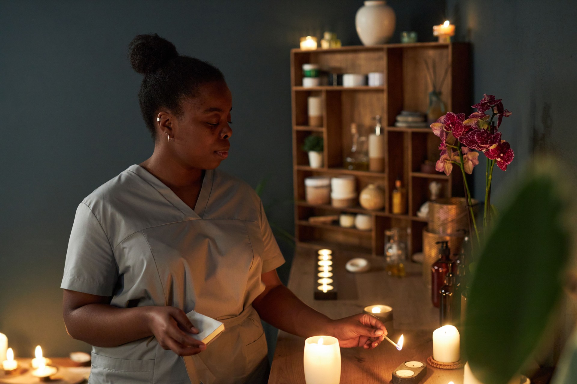 Practicing Holistic Healing in Wellness Center with Candles Practicing Holistic Healing in Wellness Center with Candles